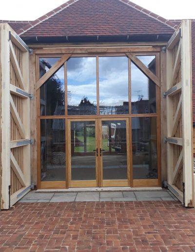 Timber barn doors with glazed screen